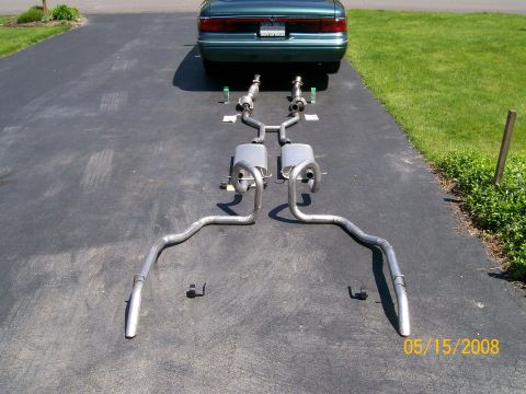 1995 Mercury Grand Marquis - Complete dual stainless exhaust system with mufflers laid out on a driveway behind a green sedan; dated 05/15/2008.
