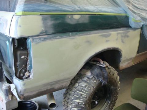 1996 Ford Bronco - Photograph of a Bronco front fender in body filler and primer during paint preparation, not a technical document.