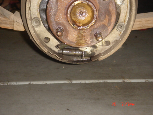 Close-up of a drum brake assembly with brake shoes, springs, and wheel cylinder.