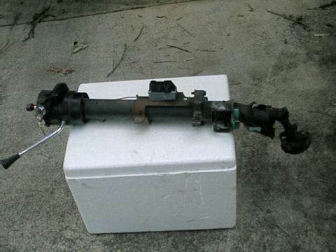 1976 Ford Ranchero - A black steering column assembly, likely from a 1970s era vehicle, rests on a white styrofoam cooler. The assembly includes a turn signal l…