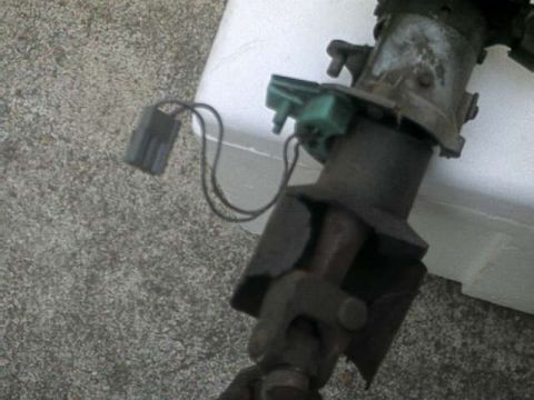 1976 Ford Ranchero - A close-up view of a steering column component with a green electrical connector and wiring. The part appears to be made of metal and plast…