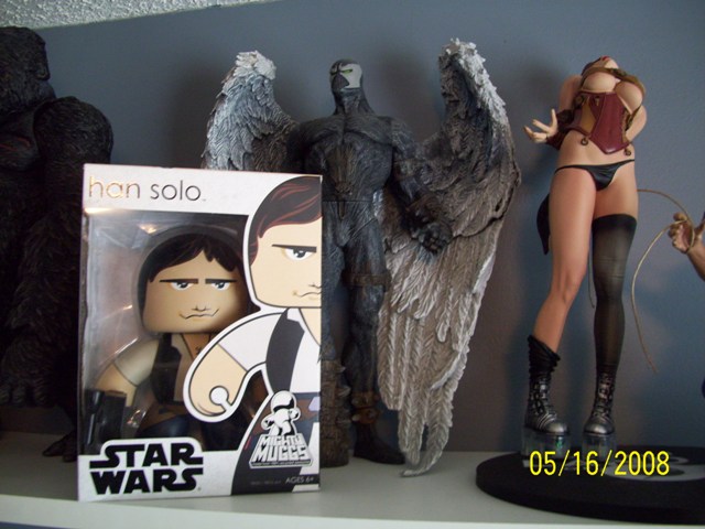 Collection of action figures including Han Solo, Spawn, and a female figure.