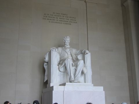 1991 Ford LTD Crown Victoria - seated white marble statue of Abraham Lincoln sits beneath a carved wall inscription, with visitors silhouetted below.