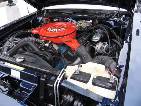 1991 Ford LTD Crown Victoria - Close view of a restored V8 engine bay with a red air cleaner marked 440 and a white plastic reservoir beside it.
