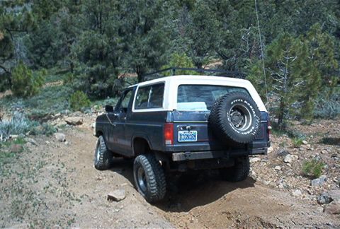 1986 Ford Bronco - This 1986 Ford Bronco navigates a dirt path, its off-road capabilities.