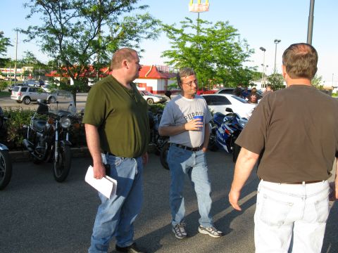 1985 Ford LTD Crown Victoria - Photograph of riders in a parking lot, not a technical document.