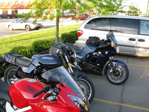 1985 Ford LTD Crown Victoria - Photograph of parked motorcycles in a parking lot, not a technical document.