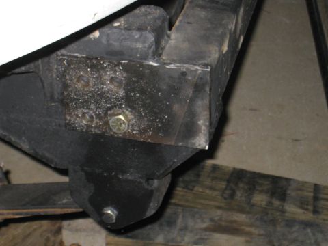 1996 Ford Bronco - Close-up view of a vehicle's frame showing a bolted bracket and suspension component.