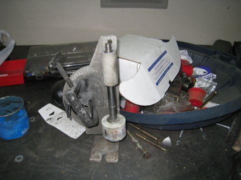 1996 Ford Bronco - Workbench setup with a hole saw jig and assorted hardware, not a 1996 Ford Bronco.