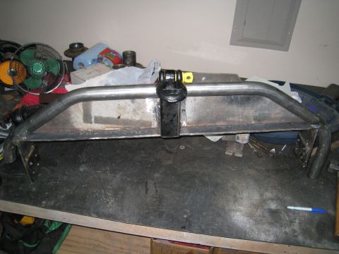1996 Ford Bronco - A custom-made bumper assembly with a hitch receiver is shown on a workbench, with various tools and items in the background.