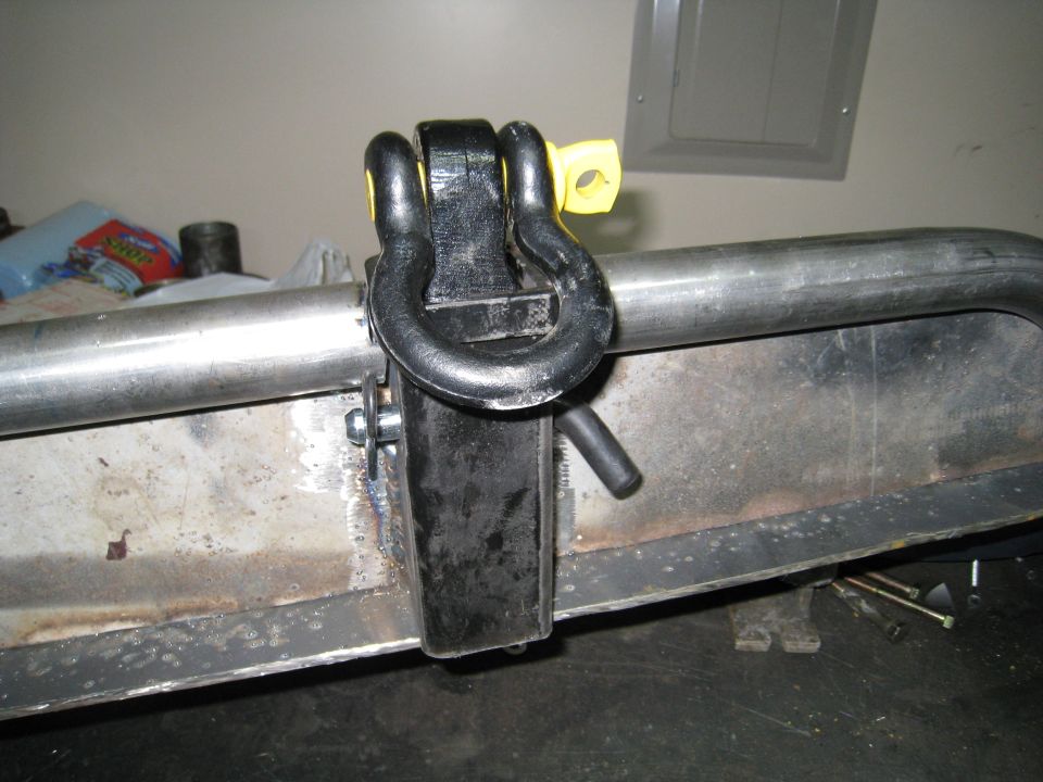 Tow hitch shackle attached to a metal bumper