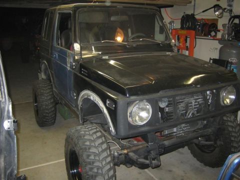 1987 Suzuki Samurai - This Suzuki Samurai features a lifted suspension and oversized tires, suggesting off-road modifications.