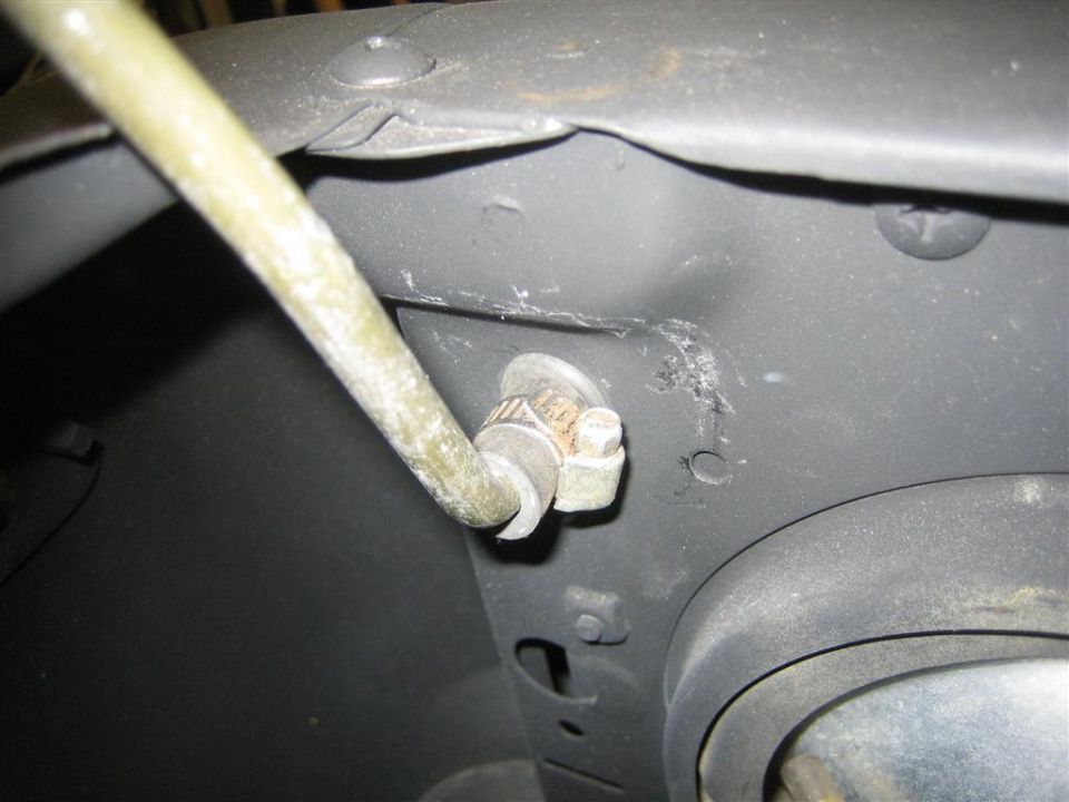 Close-up of hood prop rod in its bracket bolted to black sheet metal