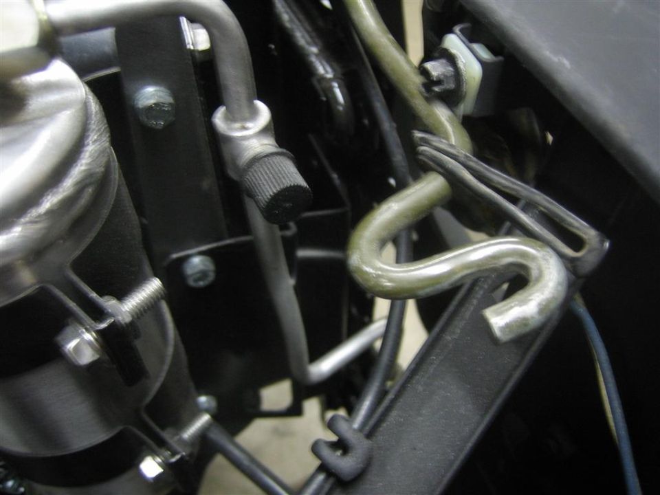 Close-up of vehicle AC hose clamp and bracket