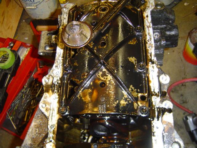 Dirty engine oil pan and oil pickup screen