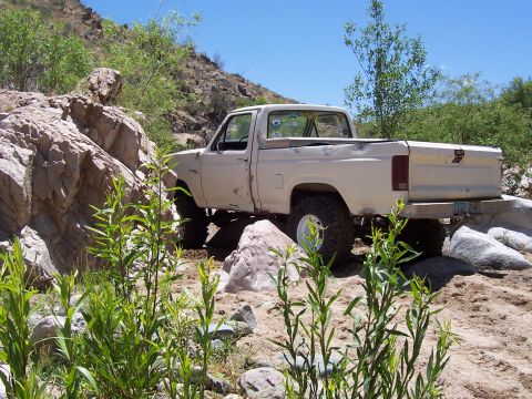 1981 Ford F-150 - Pickup truck navigating a challenging rocky path off-road.