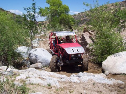 1981 Ford F-150 - This custom off-road buggy navigates a rocky terrain, its build and suspension.