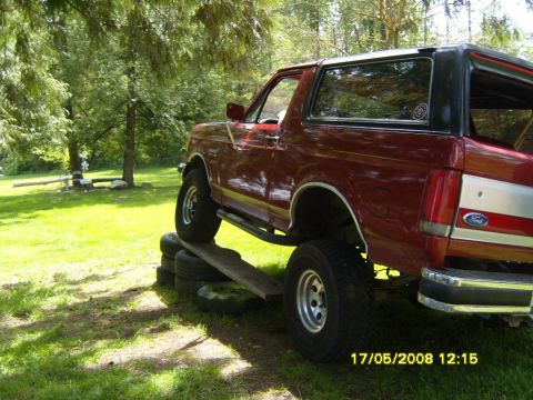 1989 Ford Bronco - 1989 Ford Bronco positioned on a ramp and tires for articulation demonstration.