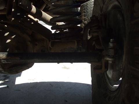 1978 Jeep Cherokee - This photo shows the undercarriage of a vehicle, focusing on the axle and suspension components.