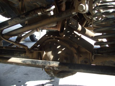 1978 Jeep Cherokee - Close-up view of a vehicle's undercarriage, focusing on the differential and suspension system.