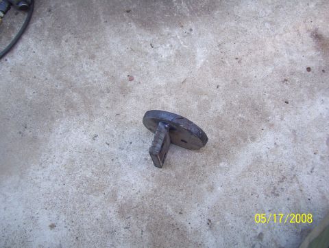 1978 Ford Bronco - A metal part, possibly a bracket, lies on a concrete floor. The date 05/17/2008 is visible.