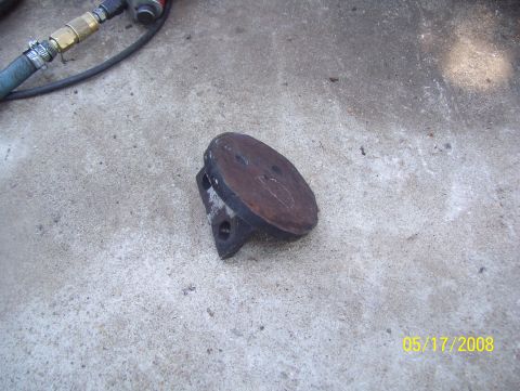 1978 Ford Bronco - A rusty metal coil mount part rests on a concrete surface, with an air hose visible in the background. The date 05/17/2008 is watermarked o…