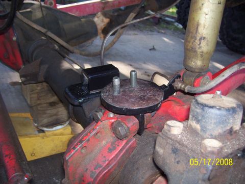 1978 Ford Bronco - This photo shows a close-up of a vehicle's suspension components, including the rear axle and shock absorber mounting hardware.