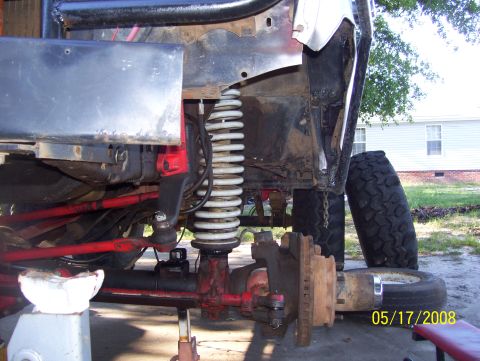 1978 Ford Bronco - The front suspension and axle components of a vehicle are shown, possibly undergoing repair or modification.