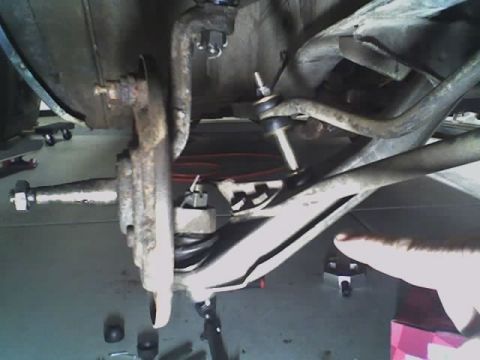 1965 Ford Ranchero - Close-up view of automotive suspension components, likely during maintenance or repair.