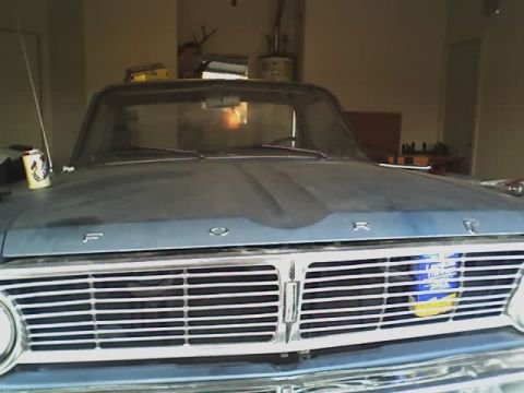 1965 Ford Ranchero - Front view of a 1965 Ford Ranchero, showing the grille and hood details.