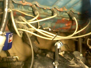 1965 Ford Ranchero - Close-up view of an engine bay with various components and wiring visible.