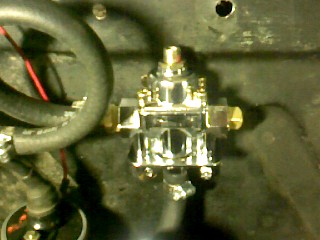1965 Ford Ranchero - A chrome fuel pressure regulator is shown, with a SuperMotors.net logo visible at the bottom.