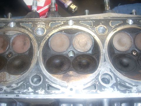 1992 Ford Bronco - Close-up of an engine cylinder head, revealing the condition of the valves and combustion chambers.