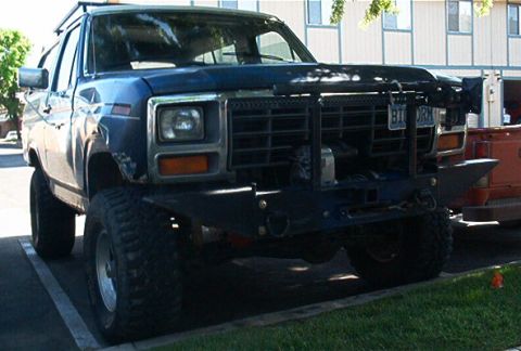 1986 Ford Bronco - This lifted Ford Bronco features a heavy-duty front bumper and a roof rack, suggesting off-road use.