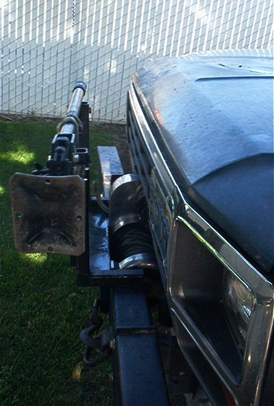 1986 Ford Bronco - A winch is mounted to the front of a vehicle, partially visible in this close-up shot.