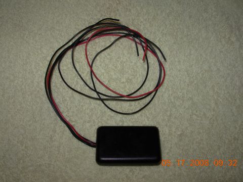 1995 Ford Taurus - Electronic module with wiring harness, likely an aftermarket accessory.