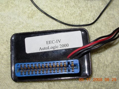 1995 Ford Taurus - A close-up shows an electronic control module labeled EEC-IV AutoLogic 2000.