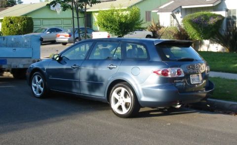 1989 Mazda MX-6 - This blue station wagon has a spoiler and a visible license plate.