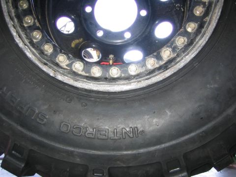 1987 Suzuki Samurai - Off-road tire and beadlock wheel detail, showing tire brand and wheel construction.