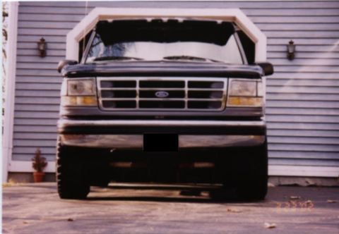 1994 Ford Bronco - Front view of a black 1994 Ford Bronco parked in front of a house.