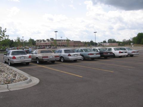 1988 Mercury Grand Marquis - Several Mercury Grand Marquis sedans are parked in a lot, showing their rear profiles.