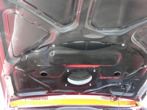 1969 Pontiac Firebird - The underside of the hood reveals the air cleaner assembly and hints of red paint on this 1969 Pontiac Firebird.