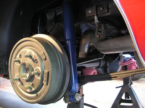 1969 Pontiac Firebird - Close-up view of the underside of a vehicle, focusing on the rear suspension and braking system.