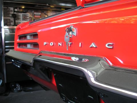 1969 Pontiac Firebird - Rear view of a red 1969 Pontiac Firebird, its iconic taillights and chrome bumper.