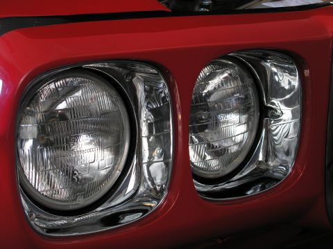 1969 Pontiac Firebird - Close-up of the dual headlights on a 1969 Pontiac Firebird's front fascia.