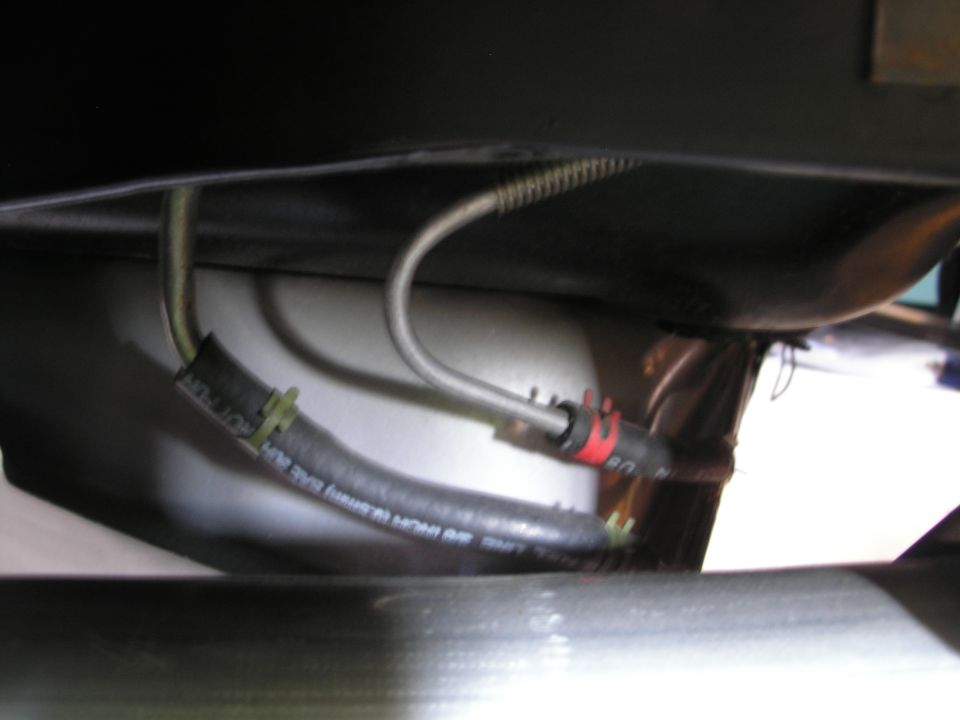 Close-up of a vehicle hose with clamps and fitting.