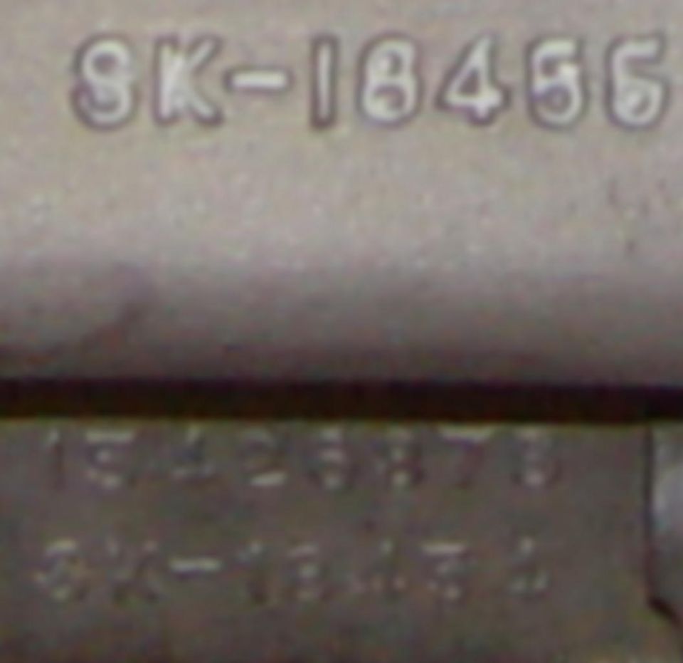 Close-up of cast aluminum part number SK-18456 raised in the casting