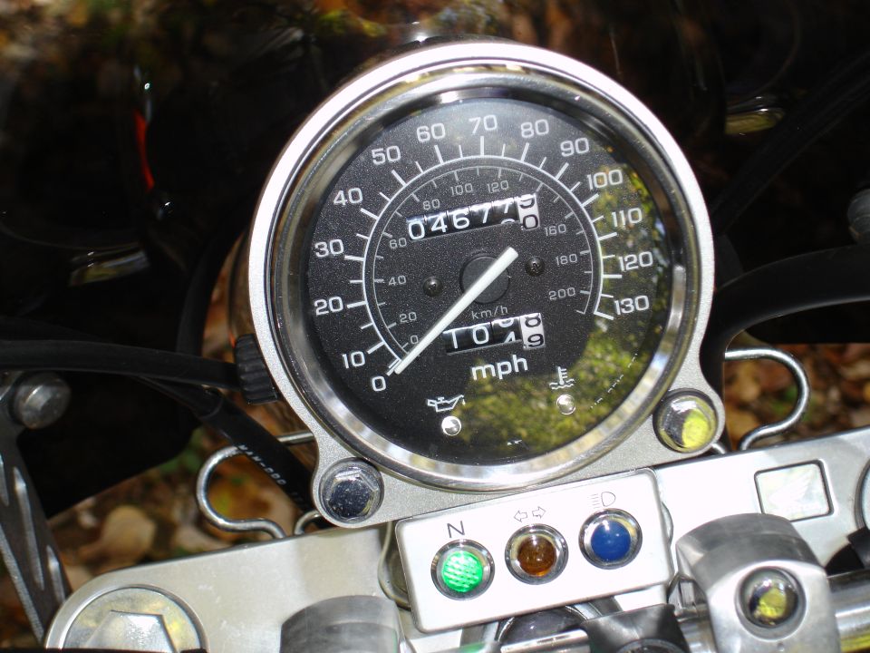 Chrome motorcycle speedometer with mph/km/h dial and indicator lights below