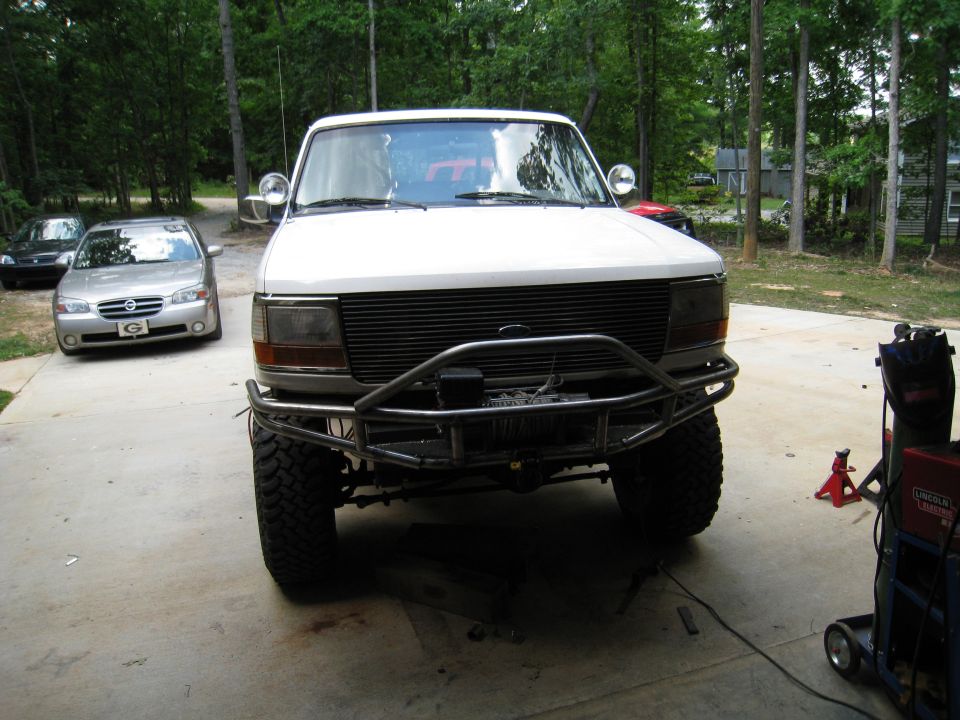 White 1996 Ford Bronco with custom bumper and winch