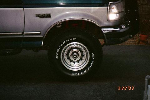 1994 Ford Bronco - Close-up of a 1992-1996 Ford Bronco's side panel, showing the fender and wheel.